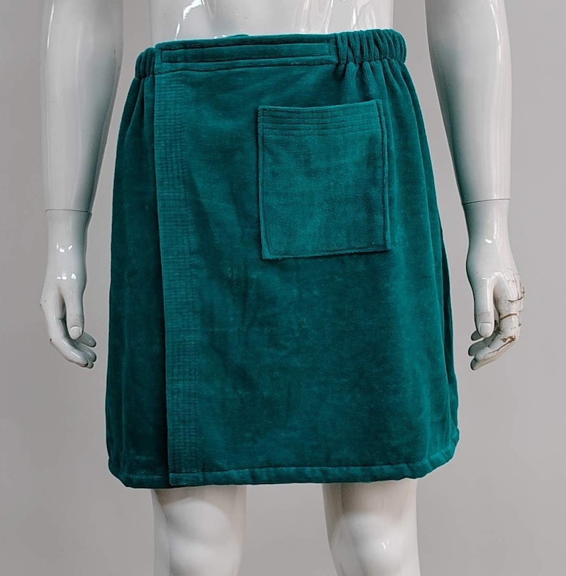 May include: A teal blue terry cloth wrap skirt with a single pocket on the front.