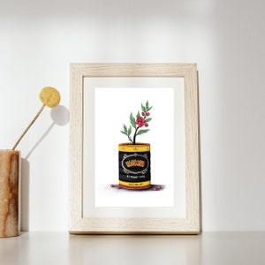 Puede incluir: Una ilustración enmarcada de una planta de café creciendo fuera de una lata de café "Vulcano". La lata es negra con letras amarillas y dice "El mejor café" y "Café Molido".