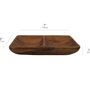 May include: A wooden serving tray with two divided sections. The tray is 7 inches long, 5 inches wide, and 1 inch deep.