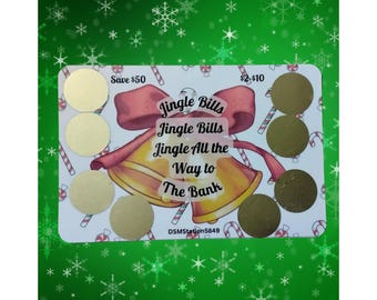 May include: A Christmas-themed scratch-off card with gold circles that can be scratched off to reveal a prize. The card features a red ribbon with the text "Jingle Bills Jingle Bills Jingle All the Way to The Bank" and the text "Save $50" and "$2-$10".