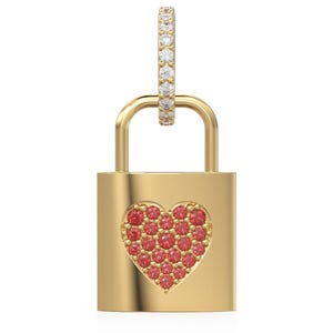 May include: A gold-colored padlock pendant with a heart-shaped design filled with red gemstones. The pendant has a small, diamond-studded hoop at the top. The background is plain white.