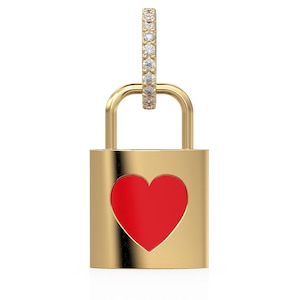 May include: Gold-colored padlock pendant with a red heart cutout. The pendant has a small hoop with clear stones. The jewelry is displayed against a white background.