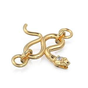 May include: A gold snake-shaped clasp with a small diamond in the snake's head.