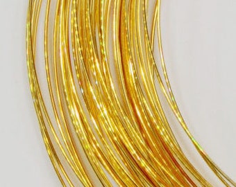 May include: A spool of gold-colored wire, wound tightly in a coil.