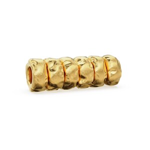 May include: Gold-toned metal bead with a textured, bumpy surface. The bead is made up of five connected rings.