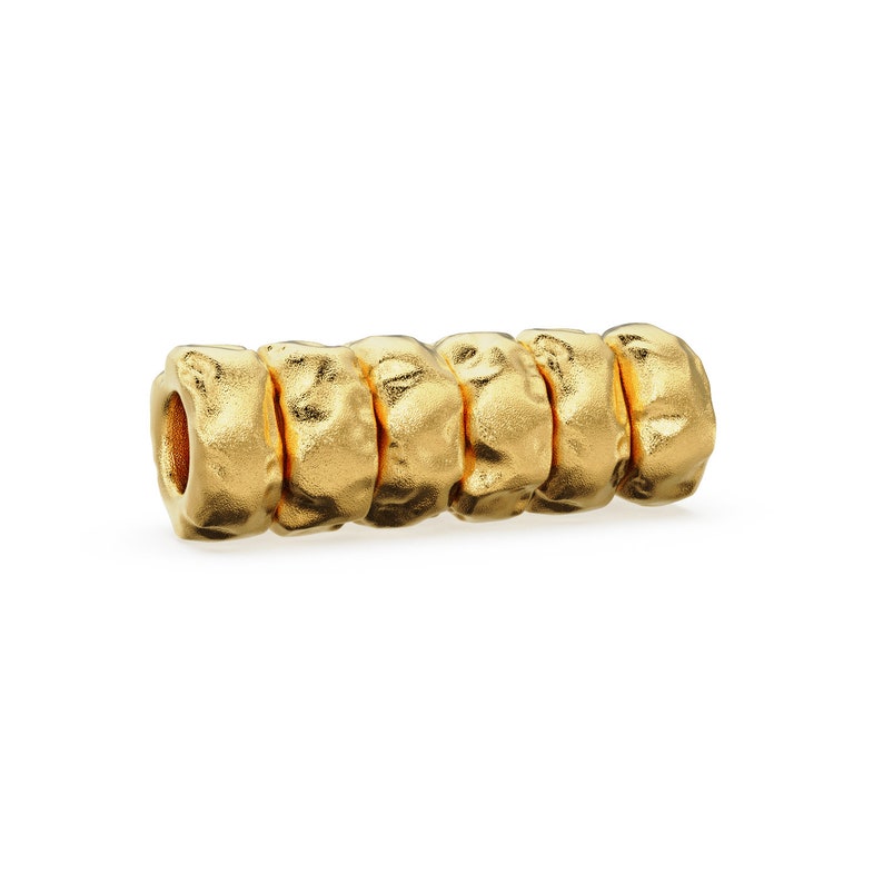 May include: Gold-toned metal bead with a textured, bumpy surface. The bead is made up of five connected rings.