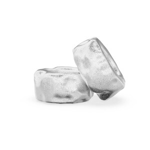 May include: Two silver rings with a textured surface.