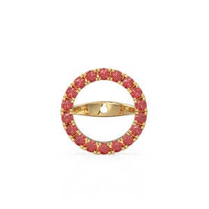 May include: A gold ring featuring a circular design, embellished with small, round, red gemstones. The ring has a band across the centre. The ring is set against a white background. The gemstones are a vibrant red colour, adding a touch of elegance.