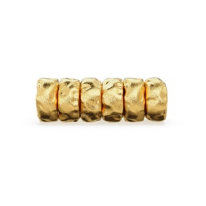 May include: A gold-colored bracelet with six textured, round beads.