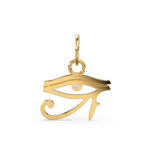 Puede incluir: Un colgante de oro con el Ojo de Horus con un peque&ntilde;o diamante en el centro. El colgante est&aacute; unido a una cadena de oro.