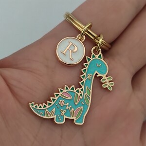 Blue dinosaur keychain in use