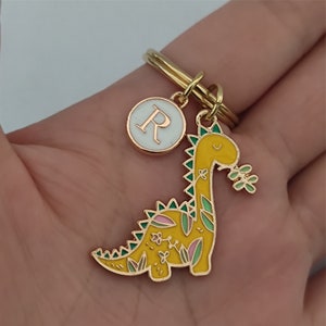 Yellow dinosaur keychain in use