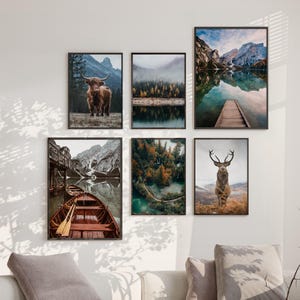 May include: A set of six framed nature photographs. The photos feature a lake with mountains in the background, a forest with a river, a highland cow, a deer, and a wooden boat on a lake.