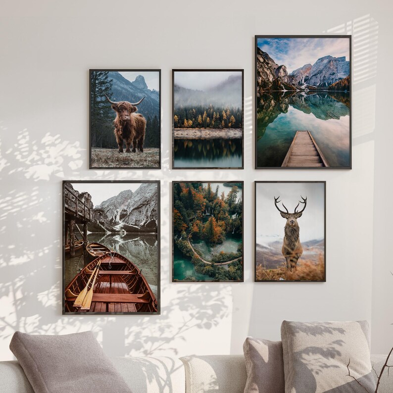 May include: A set of six framed nature photographs. The photos feature a lake with mountains in the background, a forest with a river, a highland cow, a deer, and a wooden boat on a lake.