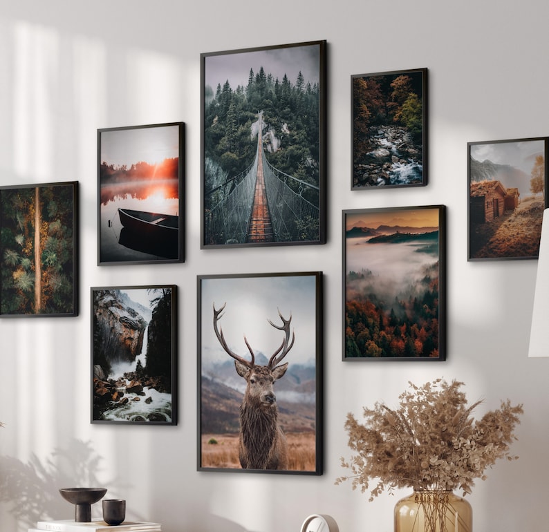 May include: A set of 9 framed nature prints featuring a variety of landscapes, including a forest, a lake, a bridge, a mountain range, and a deer. The prints are all in black frames and have a rustic, vintage feel.