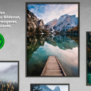 May include: A framed photograph of a mountain lake with a wooden dock extending into the water. The mountains are reflected in the still water. The image is framed in a black frame.