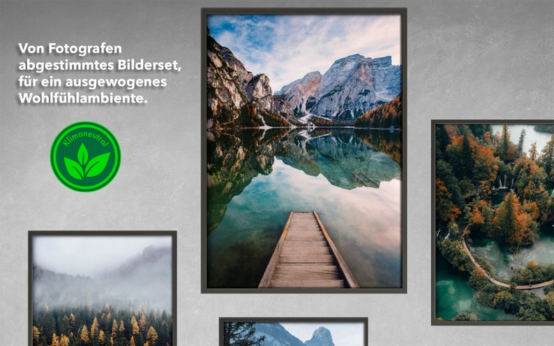 May include: A framed photograph of a mountain lake with a wooden dock extending into the water. The mountains are reflected in the still water. The image is framed in a black frame.
