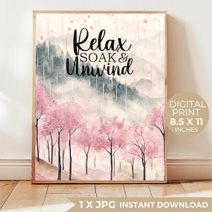 May include: A framed digital print featuring a watercolor landscape with pink cherry blossom trees and a misty mountain backdrop. The text "Relax, Soak & Unwind" is displayed in elegant script. The print measures 8.5 x 11 inches.