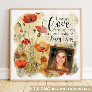 Op de afbeelding: Een ingelijste print met een aquarel bloemenontwerp, met rode en oranje klaprozen. De print bevat een foto en de tekst "Those we love don't go away they walk beside us Every Day."