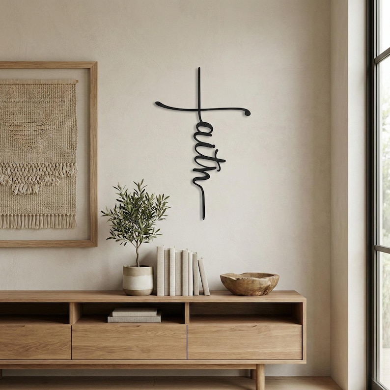 a minimalist living space with a wooden entertainment center, a potted plant, and a framed artwork on the wall.