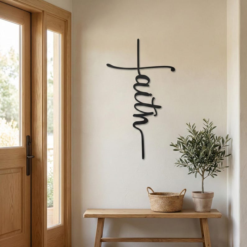 a wooden console table with a woven basket on top, and a potted plant next to it. Above the console table, there is a metal cross-shaped sign with the word "Faith" written on it.