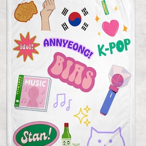 May include: White blanket with colorful K-Pop themed graphics. Includes text like "ANNYEONG!", "BIAS", "K-POP", and "Stan!". Features a heart, a cat, a music album, a bottle of soju, and a light stick.