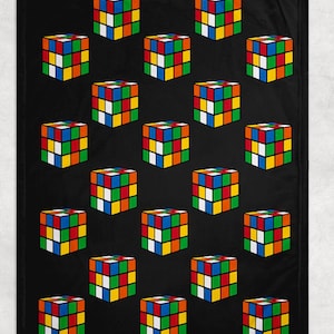 May include: Black blanket featuring a repeating pattern of colorful Rubik's Cubes. Each cube displays the classic arrangement of colored squares: red, blue, green, yellow, orange, and white. The cubes are evenly spaced across the black background.