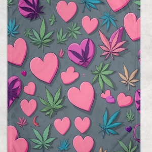 May include: A gray blanket with a repeating pattern of pink hearts and cannabis leaves in various colors, including green, blue, and purple. The design is a playful and colorful illustration.