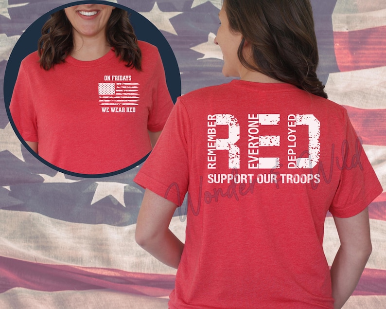 May include: Red t-shirt with white text and a small American flag graphic. The text on the front says "On Fridays We Wear Red." The back of the shirt features the word "RED" with the phrases "Remember Everyone Deployed" and "Support Our Troops."