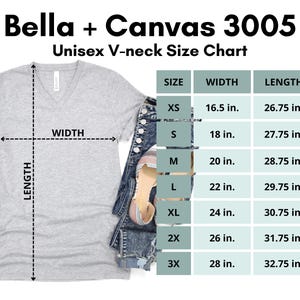 May include: A light gray Bella + Canvas 3005 unisex V-neck t-shirt with a size chart. The chart shows measurements for width and length in inches, ranging from XS to 3X. The shirt is paired with denim shorts and a sandal.