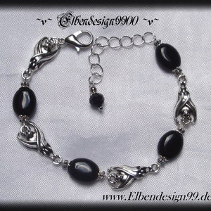 Armband mit schlafenden Fledermäusen und schwarzen Onyx-Perlen.
Karabinerschluss und Verlängerungskettchen mit schwarzer Glasperle am Ende.