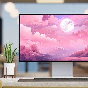 K&ouml;nnte beinhalten: Ein Computermonitor zeigt eine rosa und violette Landschaft mit einem gro&szlig;en, wei&szlig;en Mond und Sternen. Der Monitor steht auf einem Schreibtisch mit einer Pflanze in einem wei&szlig;en Topf und einer Tastatur.