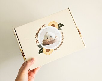 May include: A DIY crochet kit in a beige box with a sunflower design. The box features a circular image of a crocheted onion in a basket. Text on the box reads "DIY Crochet Kit" and "EMI Creations by Chloe".