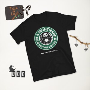 May include: Black t-shirt featuring a green and white logo that reads "I'm a Nightmare Before Coffee & Sometimes After". The logo depicts a cartoon character wearing a green hat and a black and white striped suit.