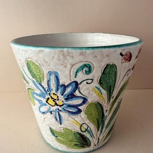 May include: A rustic wooden sign with the text "Welcome to our home" in white lettering. The sign has a distressed finish and a simple, inviting design, ideal for front door decor.