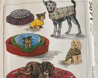 May include: A sewing pattern for making dog beds and coats. The pattern includes instructions for making a bed with a bone print and a coat with a plaid pattern. The pattern is from McCall's Crafts and is number 3071.