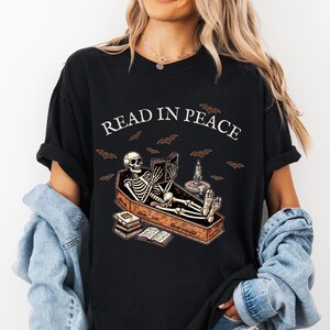 Read in Peace shirt, Skeleton Book Shirt, Skeleton Reading shirt, Book Lover Halloween tee, Reading Shirt, Bookish Gift, Halloween shirt