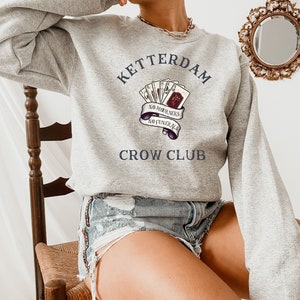 Zes van Kraaien Sweatshirt, Ketterdam Crow Club Trui, Kaz Brekker, Zes van Kraaien Kaarten, Inej Ghafa, Nina Zenik, Jesper Fahey, Matthias Helvar