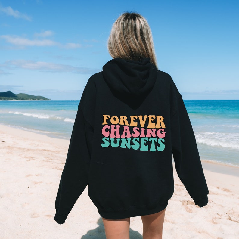 May include: Black hooded sweatshirt with the text "FOREVER CHASING SUNSETS" in colorful retro font on the back.