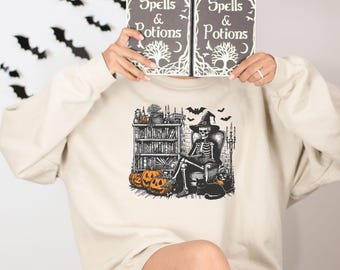 Witch Skeleton Reading Book Sweatshirt, Spooky Book Lover Crewneck, Halloween Witchy Skeleton Shirt, Cozy Fall Sweatshirt for Readers