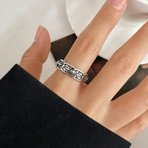 Puede incluir: Anillo de plata con un diseño intrincado y detallado. El anillo es ancho y tiene una superficie texturizada.
