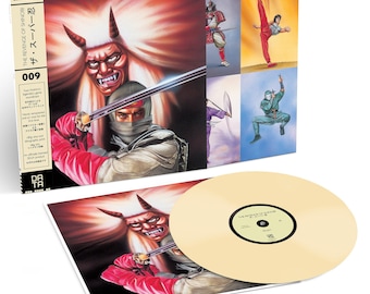 May include: A vinyl record set of the soundtrack for the video game "The Revenge of Shinobi". The cover art features a red-faced demon with white hair and a ninja holding a sword. The record is a light yellow color.