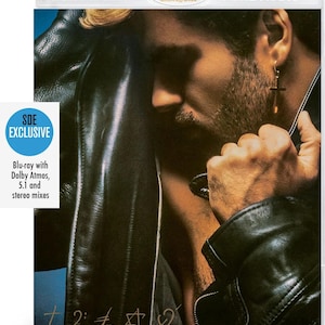 May include: Blu-ray disc with the text "HIGH FIDELITY" and "PURE AUDIO". The cover features a man in a black leather jacket. The disc is labeled "SDE EXCLUSIVE" and includes "Blu-ray with Dolby Atmos, 5.1 and stereo mixes".