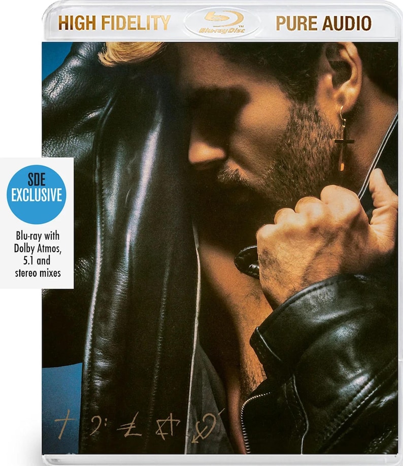 May include: Blu-ray disc with the text "HIGH FIDELITY" and "PURE AUDIO". The cover features a man in a black leather jacket. The disc is labeled "SDE EXCLUSIVE" and includes "Blu-ray with Dolby Atmos, 5.1 and stereo mixes".
