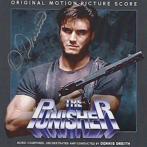 May include: The Punisher movie soundtrack CD cover features a man holding a gun, with the title "The Punisher" in a bold, metallic font.