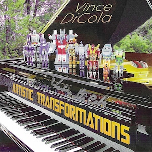 May include: A black grand piano with the words "ARTISTIC TRANSFORMATIONS" in yellow lettering. Several colorful toy robots stand on the piano. The album cover features the text "Vince DiCola".