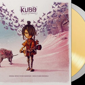 May include: Kubo and the Two Strings original motion picture soundtrack vinyl record. The album art features a stylized illustration of Kubo, a monkey, and a flock of birds. The vinyl record is gold in color.
