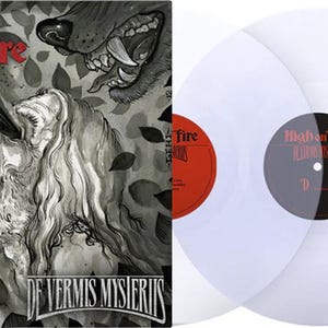 May include: Album cover art for "De Vermis Mysteriis" by High on Fire. The cover features a detailed black and white illustration of a person with eyes emitting beams of light, and a wolf. Two white vinyl records are on the right.