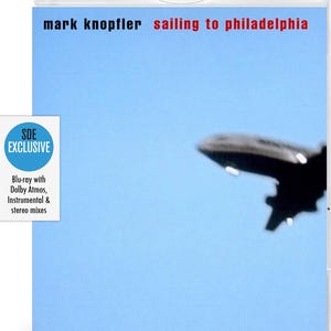 May include: Blu-ray disc case for Mark Knopfler's album "Sailing to Philadelphia." The cover features the album title and artist name in black and red text against a light blue sky. A blurred image of an airplane is in the background.