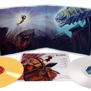 May include: A vinyl record set featuring artwork from the movie "Kubo and the Two Strings." The set includes two vinyl records, a gold and a silver one, and a gatefold album cover with illustrations of characters and scenes from the film.